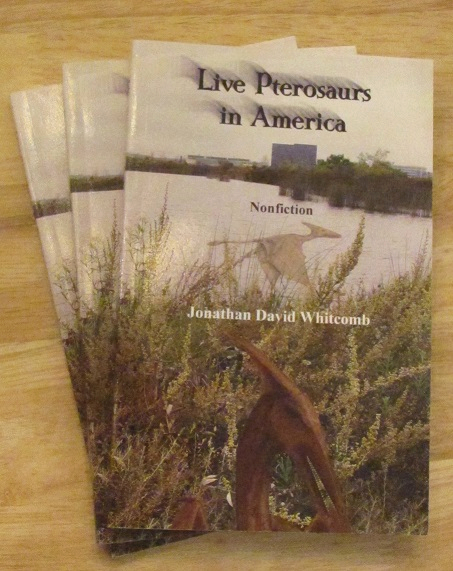 pile of three paperback books: Live Pterosaurs in America